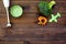 Make baby food at home. Puree with broccoli near immersion blender and toy on dark wooden background top view copy space