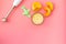 Make baby food at home. Puree with pumpkin near immersion blender, toy on pink background top view copy space