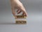 Make distinction symbol. Concept words make distinction on wooden blocks. Beautiful grey background. Businessman hand. Business