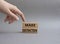 Make distinction symbol. Concept words make distinction on wooden blocks. Beautiful grey background. Businessman hand. Business