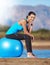 Make them wonder why youre smiling. a young woman taking a break on her exercise ball.