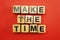make the time letters alphabet wooden cubes on red background