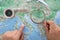 Make a travel plan by studying the map of Europe with a magnifying glass in hand