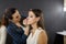 A make-up artist is applying makeup to a young girl.