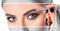 Make-up artist does eyebrow make-up to a woman with smoky eyes makeup. Beautiful thick eyebrows close up. Professional makeup and