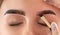 The make-up artist does Long-lasting styling of the eyebrows of the eyebrows and will color the eyebrows. Eyebrow lamination.