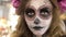 Make-up artist make the girl halloween make up in studio.Halloween face art.Woman applies on professional