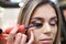 Make up artist makes eyelashes for her model