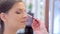 Make-up artist puts make-up on model\'s eyes close-up