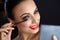 Make-up. Beautiful Woman Doing Makeup. Mascara Brush. Red Lips