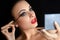 Make-up. Beautiful Woman Doing Makeup. Mascara Brush. Red Lips