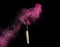 Make-up brush with pink powder explosion on black