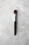 Make up brush synthetic hair with black wood handle on luxury marble background. Cosmetic brush for face tone, blush