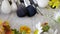 Make-up brushes laying on wooden table next to flowers