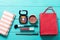 Make up cosmetic and accessories with red bag on blue wooden background. Top view and mock up.