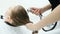 Make-up and hair-style beauty concept. Washing ginger hair with tap water. Close up of tilting over person hair in focus