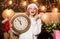 Make wish. Happy emotional girl Santa hat hold vintage clock. Time to celebrate. Merry christmas. Time for winter party