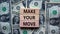 Make your move symbol. Wooden blocks with words `Make your move`. Beautiful background from dollar bills. Business, make your mo