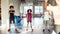 Make yourself healthy. Full-length shot of three teens, boys and girl warming up, exercising with female trainer in gym