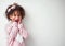 She makes the day brighter. a adorable little girl looking surprised against a grey background.