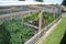 Makeshift nursery green house in outdoor community vegetable garden