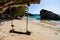 Makeshift wooden swing on a deserted tropical sandy beach