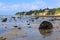 Maketu, New Zealand. Rocks on the wet sand