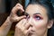 Makeup artist applying false eyelash.Make up artist doing professional make up of beautiful young woman.