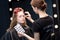 Makeup artist applying false eyelashes