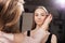 Makeup artist brushing eyebrows of a client