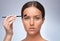 Makeup artist combs eyebrows with a brush after dyeing in a beauty salon.Professional makeup and cosmetology skin care