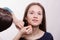 Makeup artist gets fluffy powder brush on forehead model