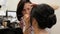 Makeup artist makes makeup of a beautiful brunette girl. stylist working on the image of the model. makeup artist draws eyes with