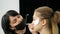 Makeup artist makes model girls a professional fashionable smoky eye makeup in beauty studio