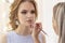 Makeup artist paints lips model with lip liner. make-up in gentle day neutral beige shades