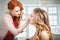 Makeup artist preparing bride before the wedding in a morning