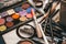 Makeup artist tools. the work table of the make-up artist. eyeshadow, blush, brushes and foundation close-up top view. cosmetics