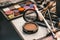 Makeup artist tools. the work table of the make-up artist. eyeshadow, blush, brushes and foundation close-up top view. cosmetics