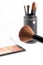 Makeup brush and earth tone eyeshadow