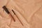 Makeup brushes and brushes still life on the background of beige fabric texture in folds of crumpled cotton in the