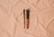 Makeup brushes and brushes still life on the background of beige fabric texture in folds of crumpled cotton in the