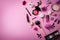 makeup cosmetics and equipment with flowers on pink background with copy space