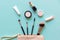 Makeup cosmetics tools and beauty cosmetics, products and facial cosmetics package lipstick, eye shadow on green pastel background