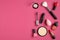 Makeup decorative cosmetics and tools on pink background. Flat lay, top view, copy space. Beauty and fashion concept