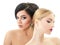 Makeup. Double female portrait. Caucasian blond girl and beautiful mulatto young woman posing in studio over white background.