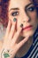 Makeup face and hand nails young woman. Conformist tattoo