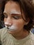 Makeup on the face of a teenager face painting a fairy-tale hero the hare for the New Year