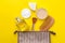 Makeup kit. Women`s cosmetics in a cosmetic bag and makeup brushes on a yellow bright background. women things. top view