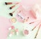 Makeup products, decorative cosmetics on pastel color pink mint background  flat lay.