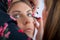 Makeup professional artist applying base color eyeshadow on model eye